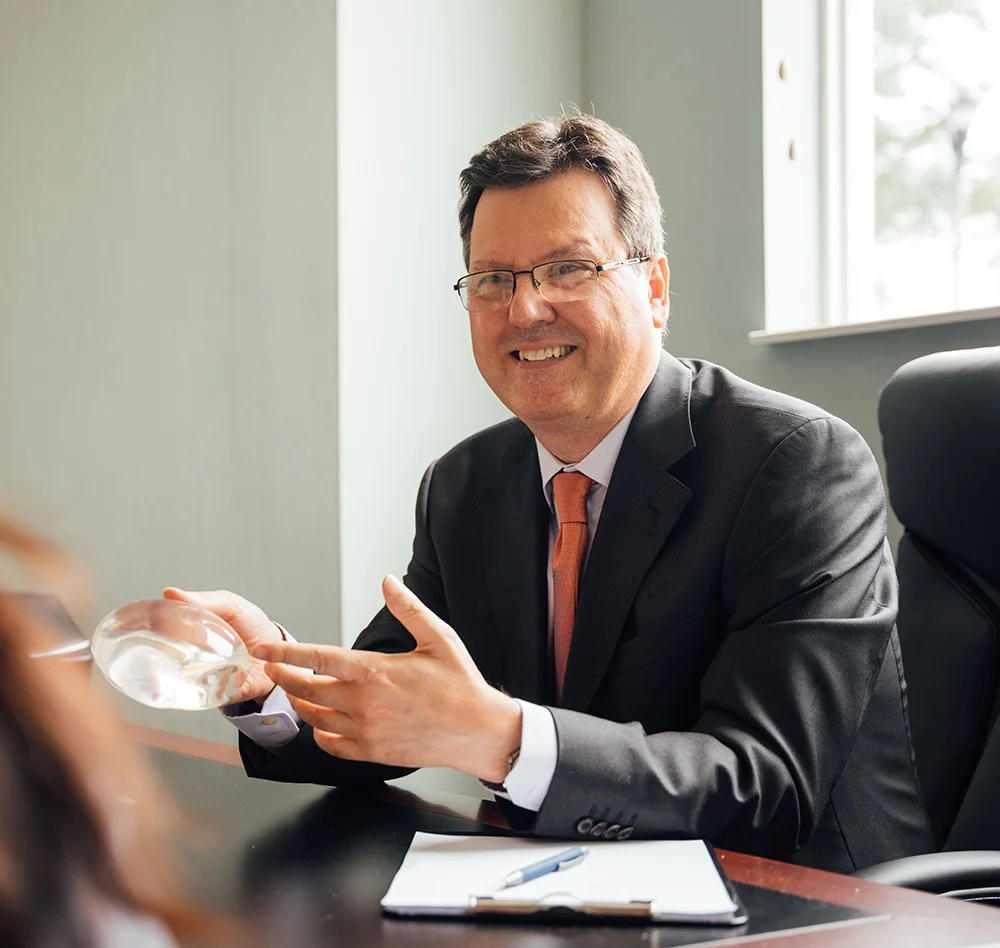 Meet Dr. Papanicolaou - George Papanicolaou, MD discusses breast implants with a patient.