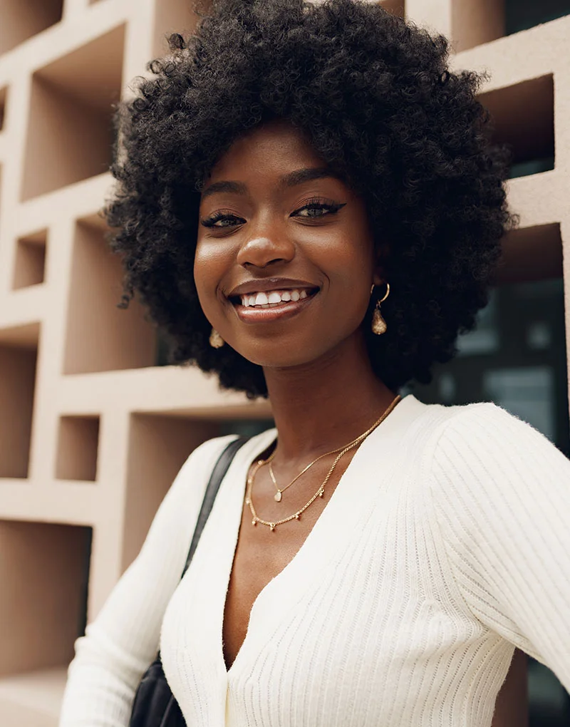 African American woman leaning against a breezeway wall | Soma Med Spa feature procedures